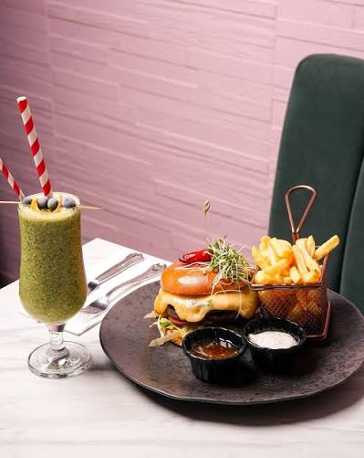 Burger and fries with a green smoothie at The Pink Olive