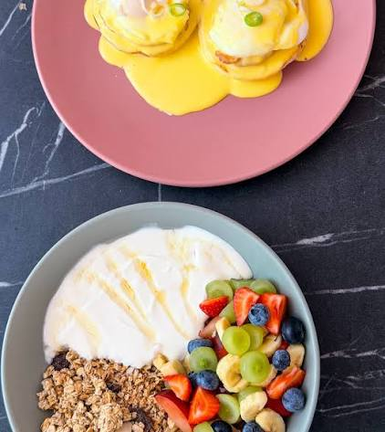 Eggs benedict and granola bowl flatlay