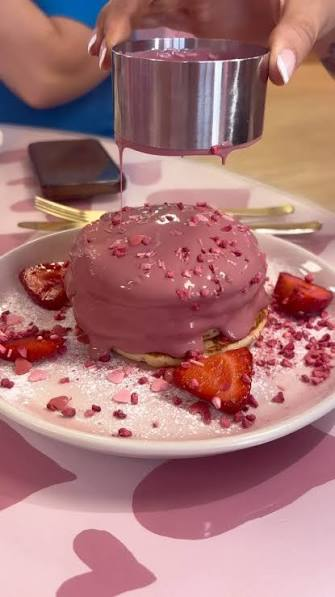 Pink glazed pancake stack with strawberries