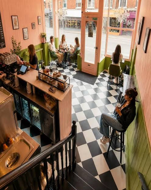 Guests at the counter and window seats at The Pink Olive